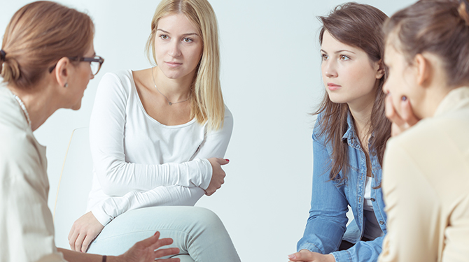 Members of a support group sitting together in conversation
